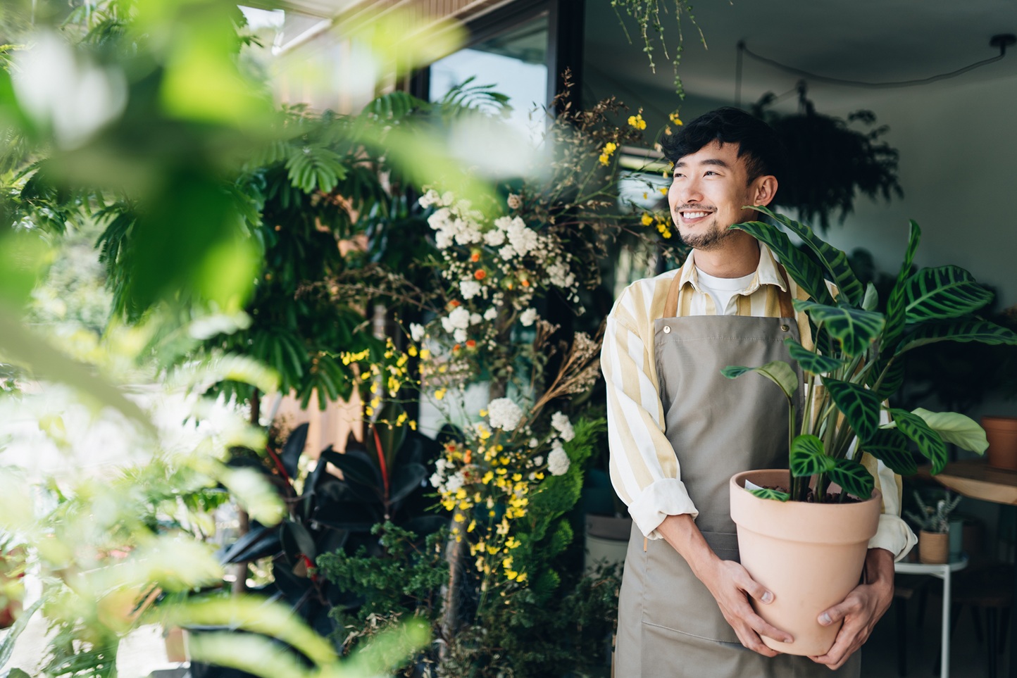Confident young Asian male florist