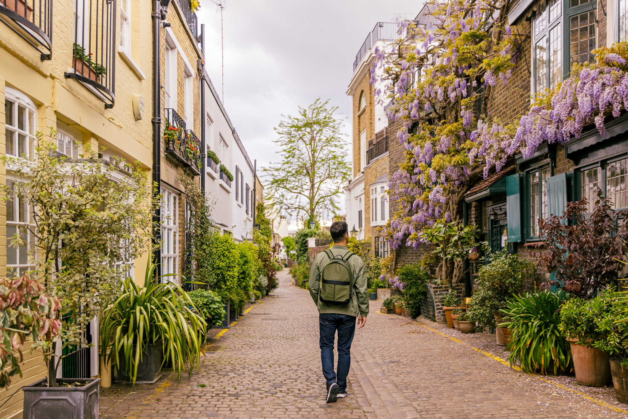 Men walking in the street surrender by flowers